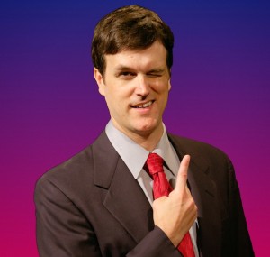 Brandon Felker is game show host Troy Richards in Theater Schmeater's production of GAME SHOW.